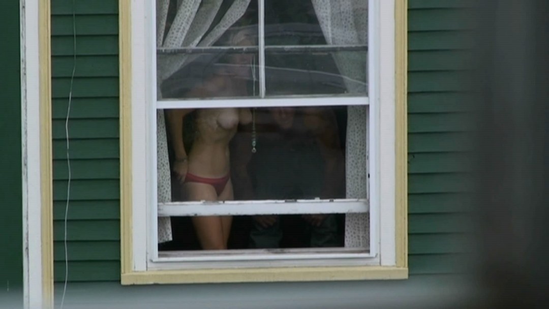 Mujeres desnudas en las ventanas de las casas