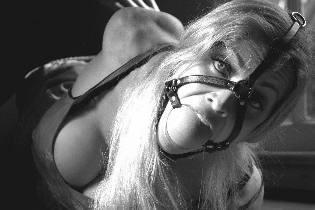 Chica con una mordaza desnuda