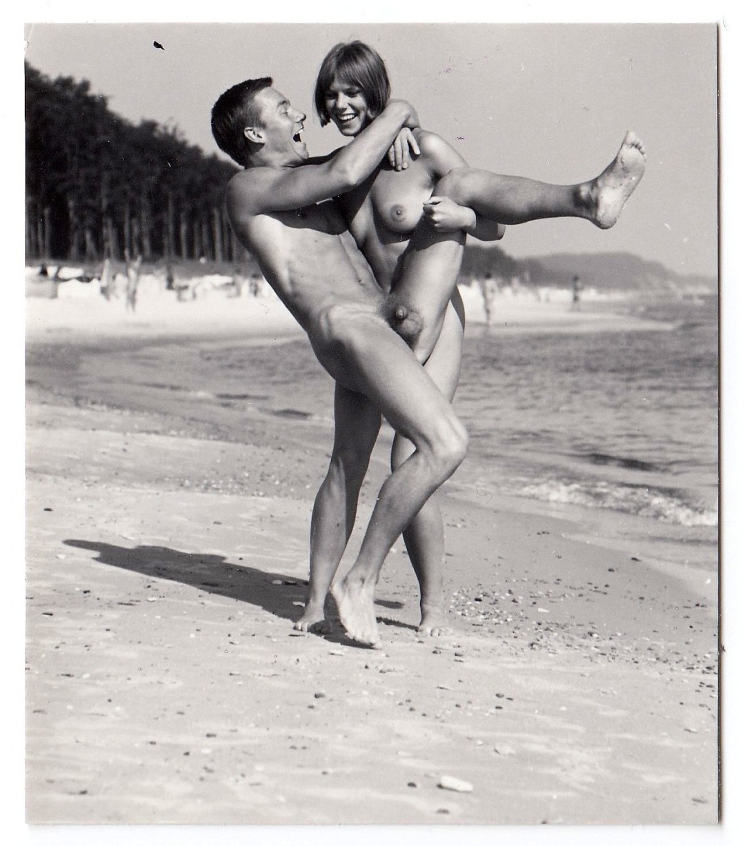 Chicas desnudas con chicos en la playa retro