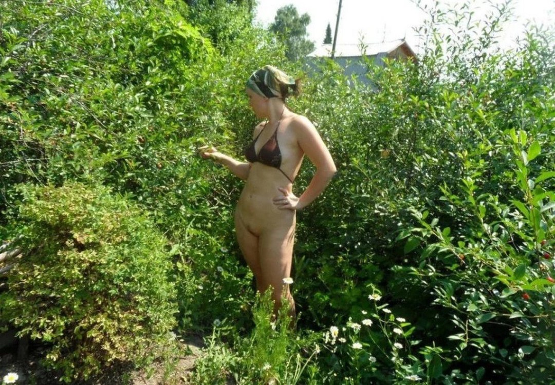 Esposa desnuda en el país en el jardín