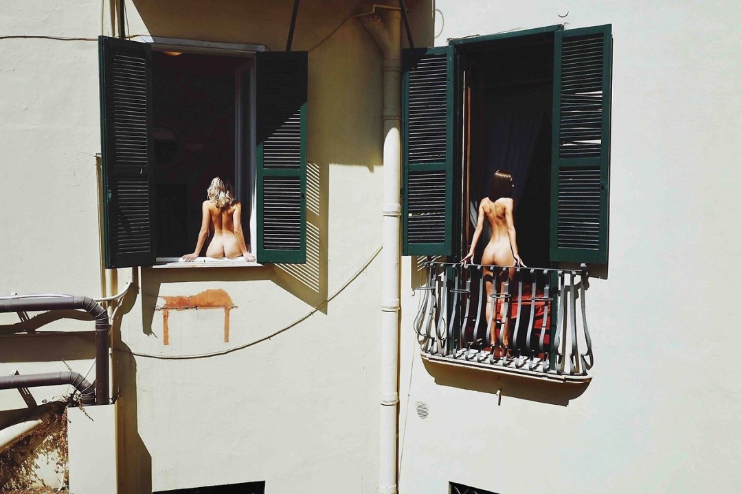 Голая вешает белье на балконе